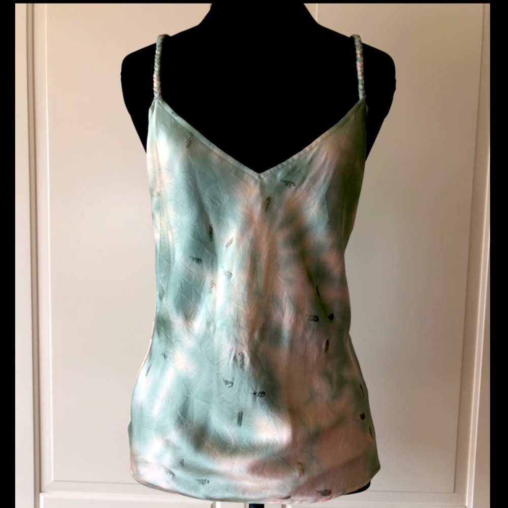 Jennifer Lopez’s aqua green and cream sleeveless top with with braided straps